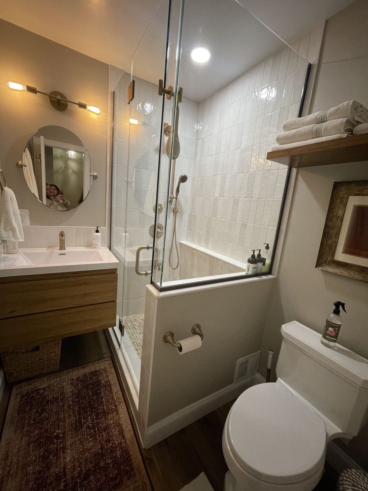 New bathroom built from closet space, with a glass-enclosed shower and wood vanity